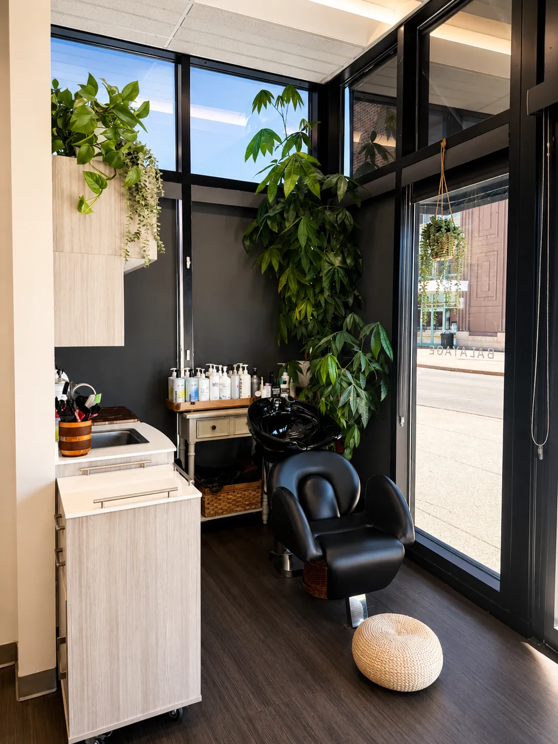 Christopher Anthony Salon interior with styling stations, illuminated mirrors, and guest seating