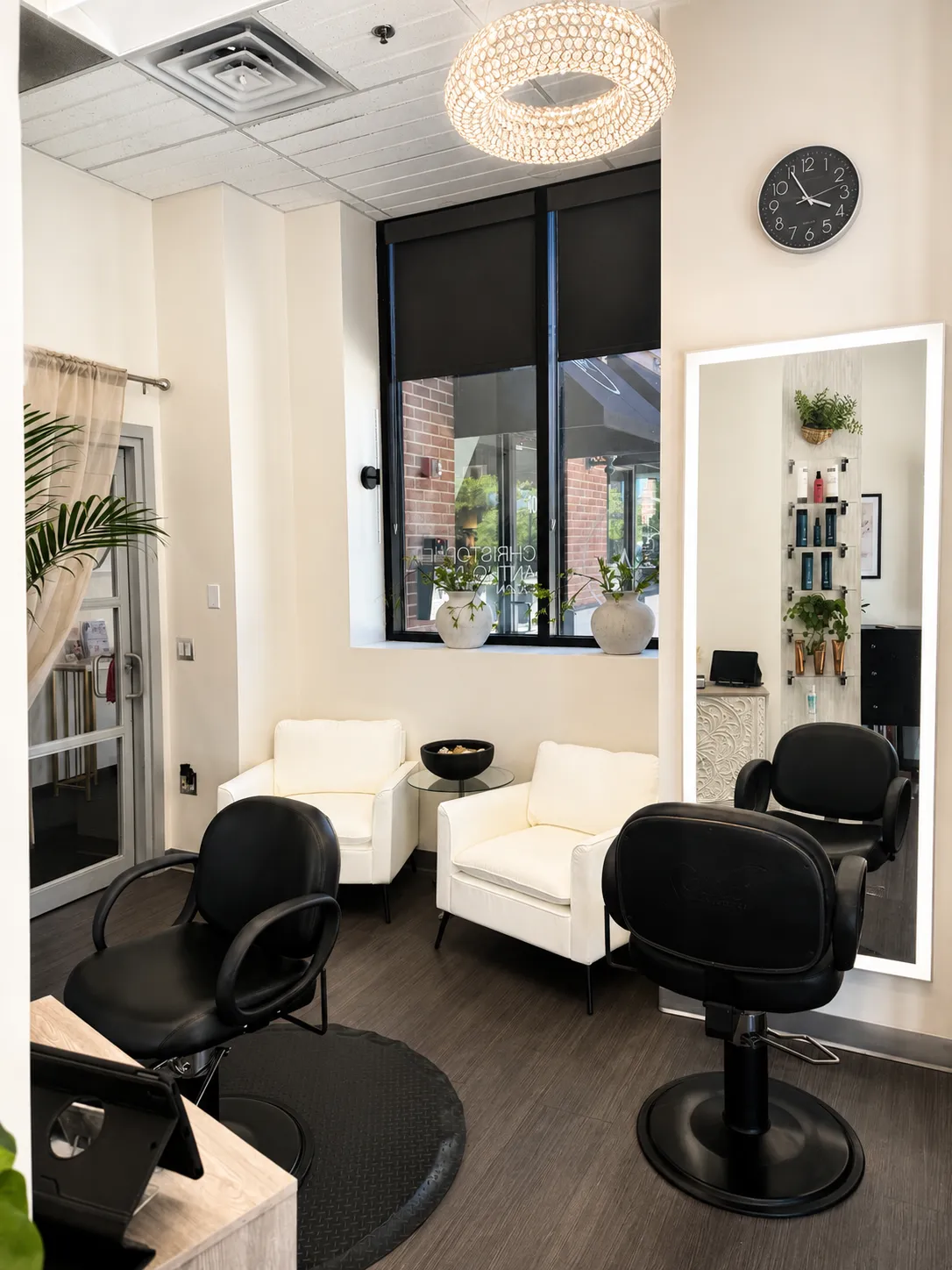 Christopher Anthony Salon interior with styling chairs, guest seating, and greenery