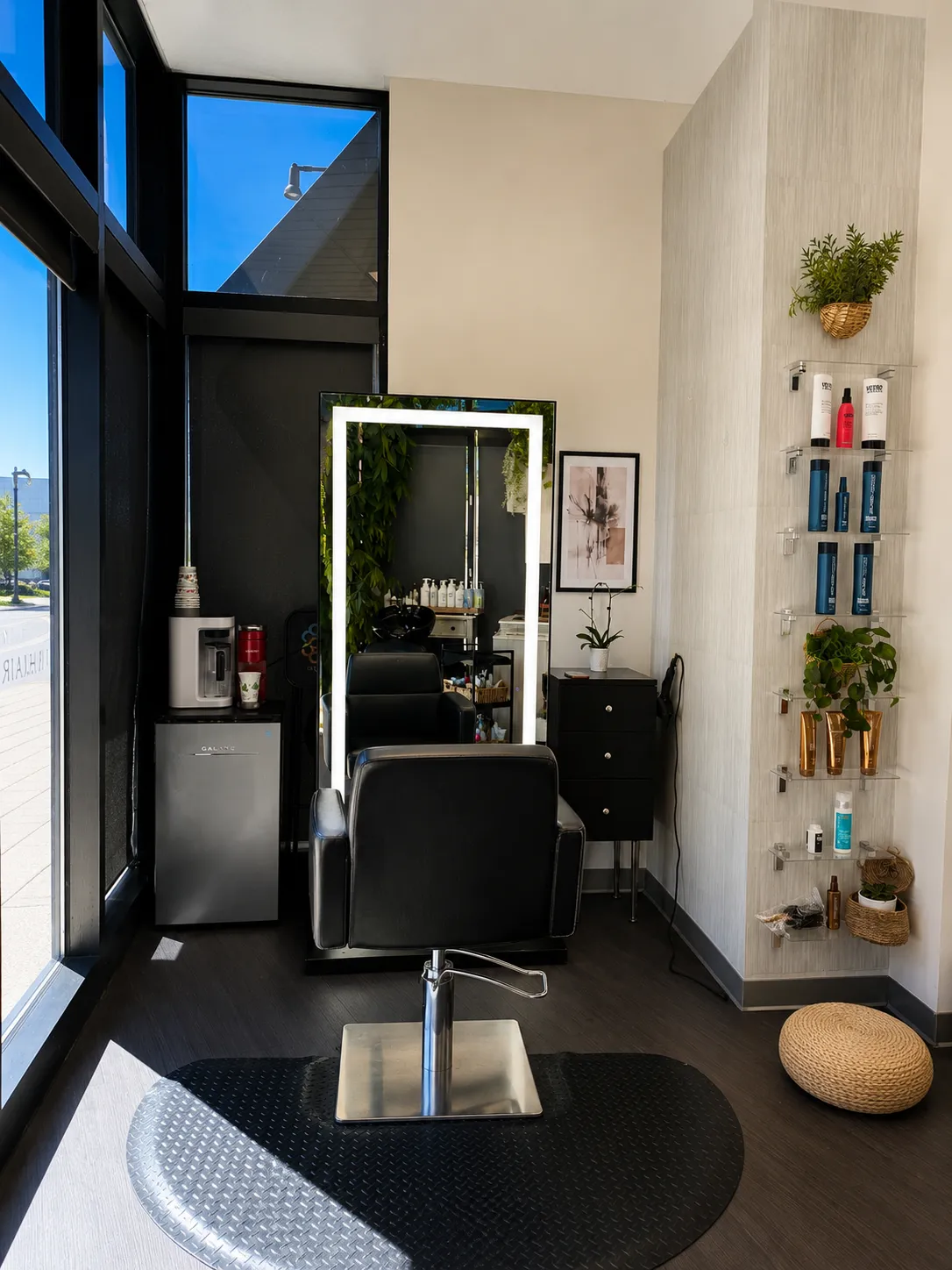 Christopher Anthony Salon styling station with a large mirror and product display