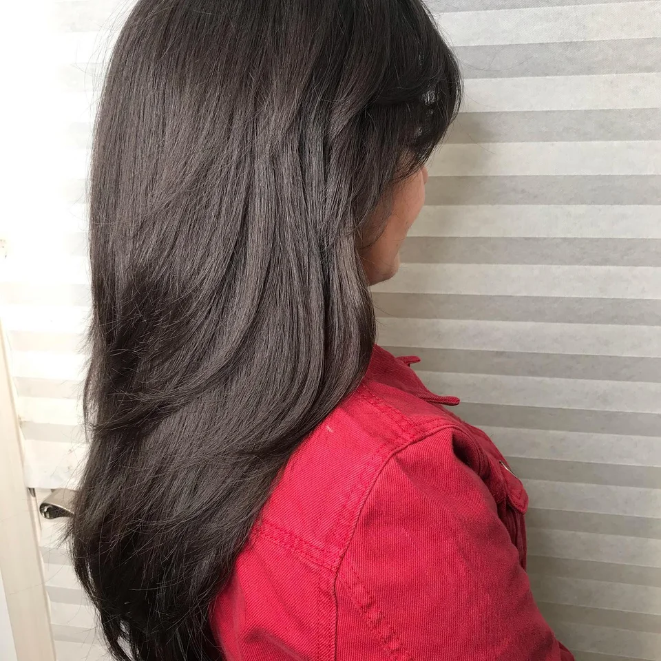 Long glossy brunette layers with a smooth finish