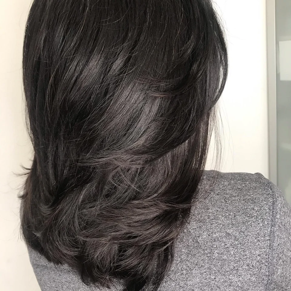 Glossy dark brunette hair with long soft layers