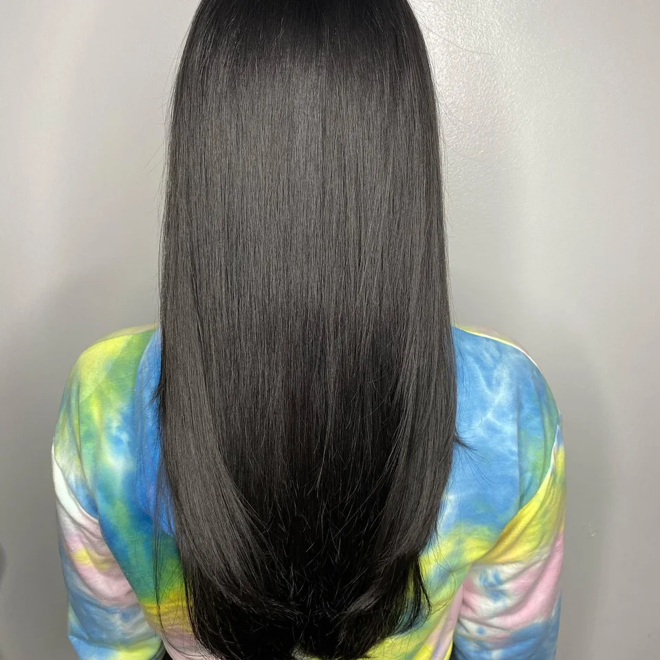 Sleek long black hair with softly layered ends