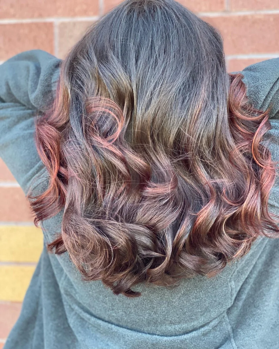 Shoulder-length brunette waves with rose-copper ends