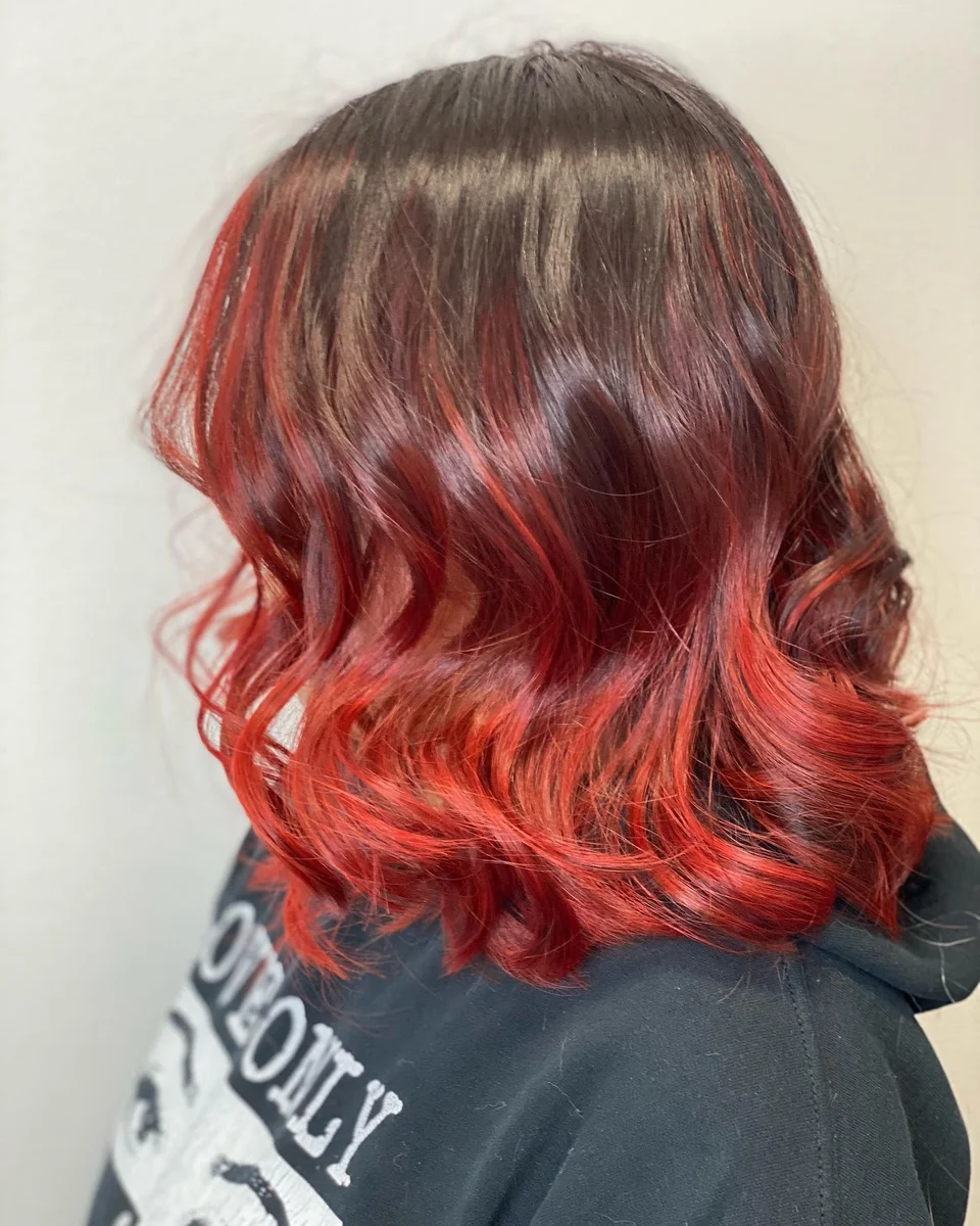 Red ombré bob styled with soft curls