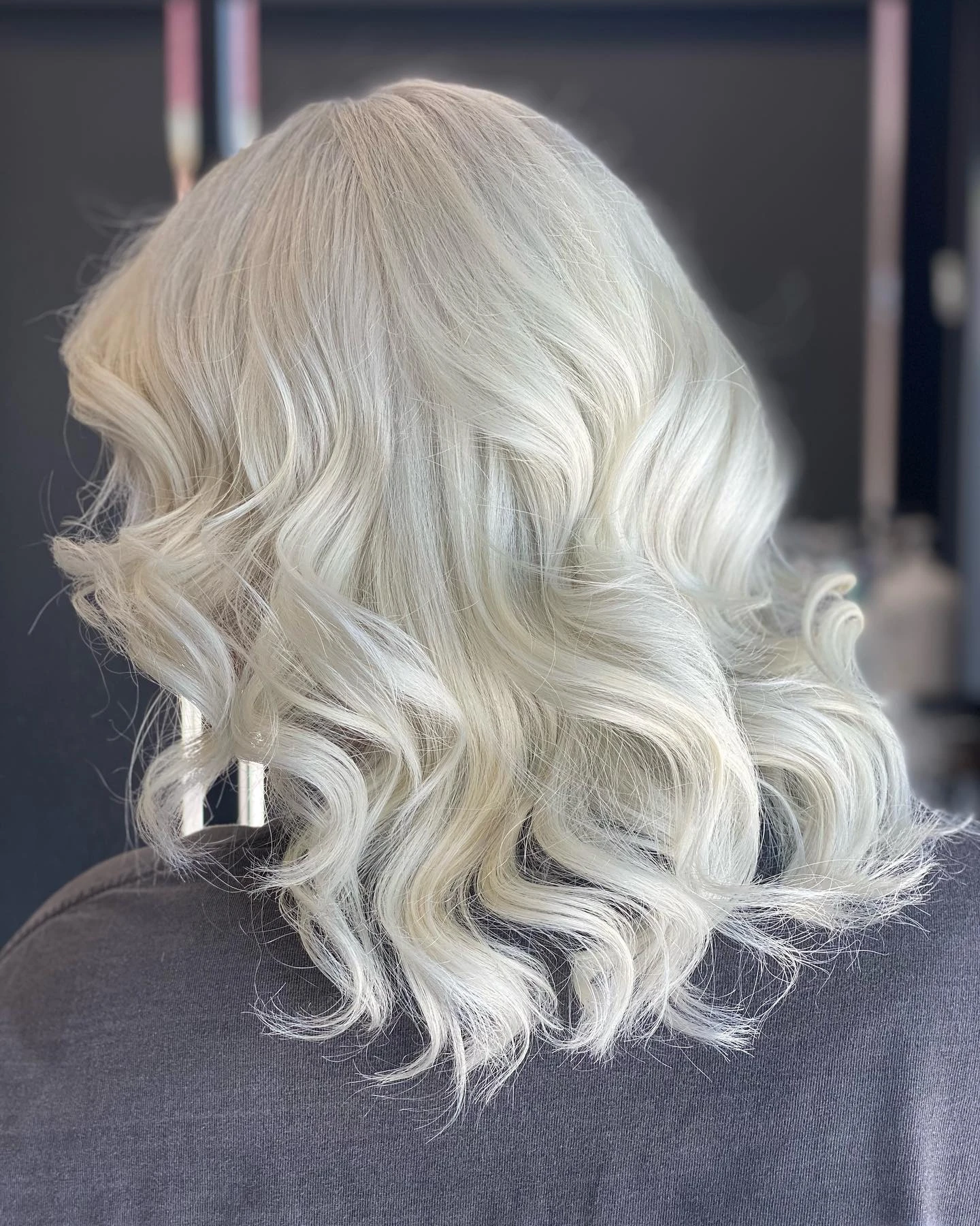 Platinum blonde hair styled in sculpted waves