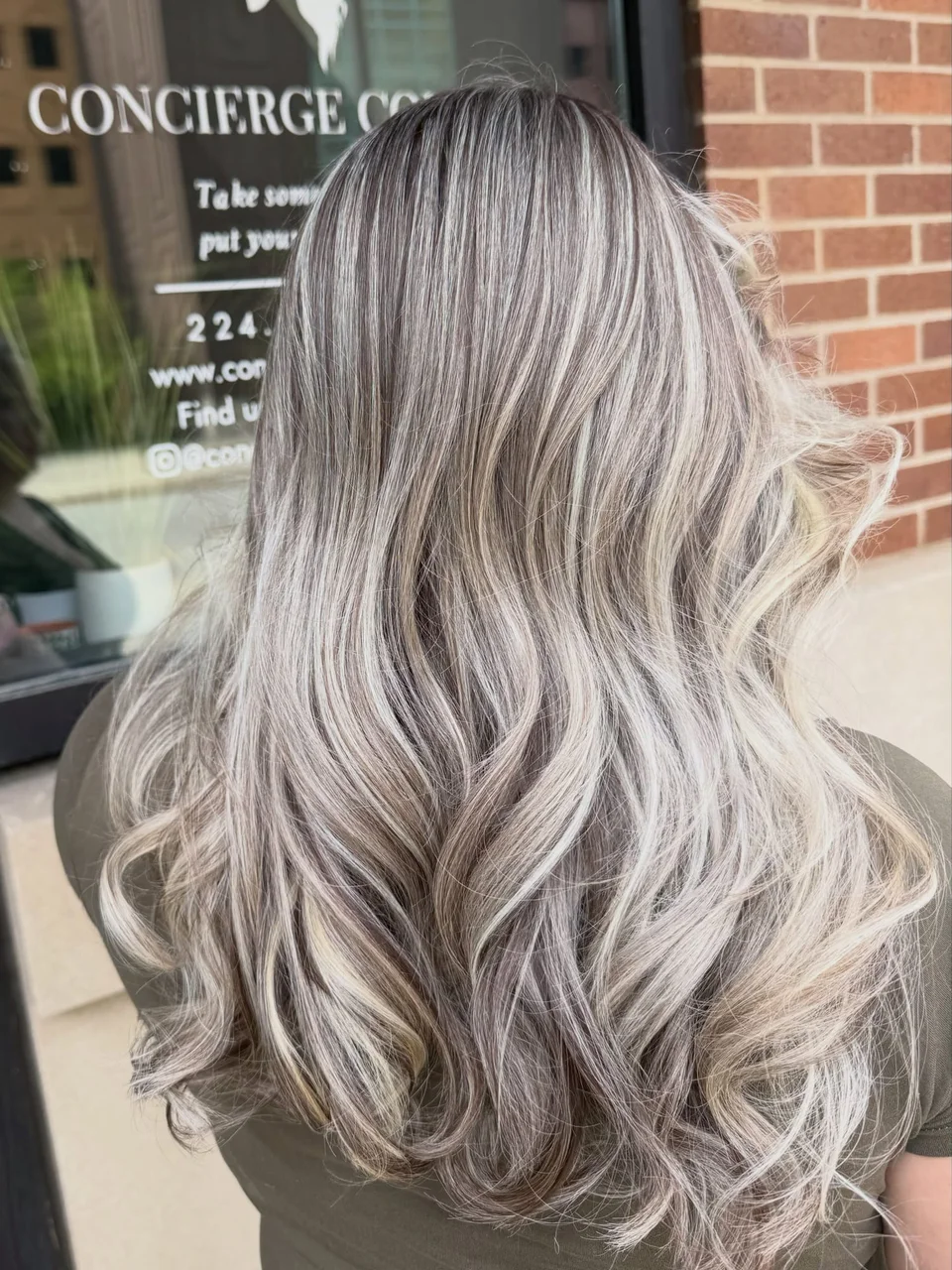 Silver ash-blonde highlights styled in soft curls