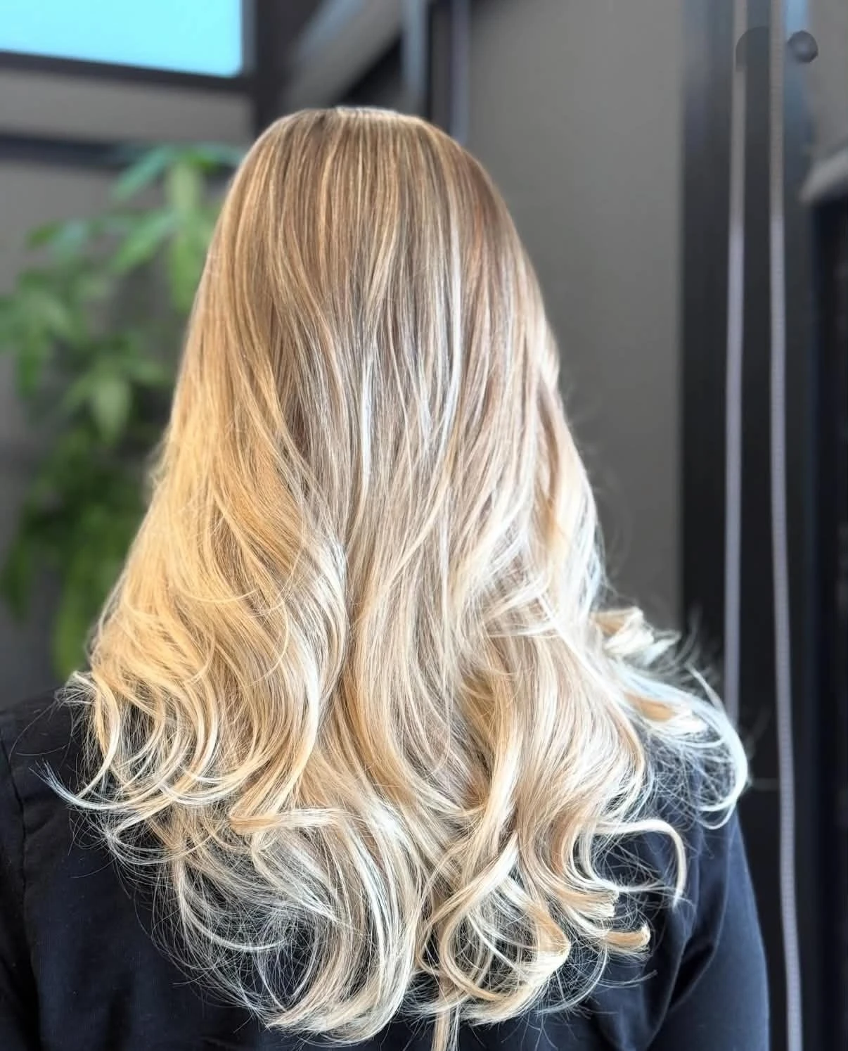 Icy blonde balayage styled in long, dimensional waves