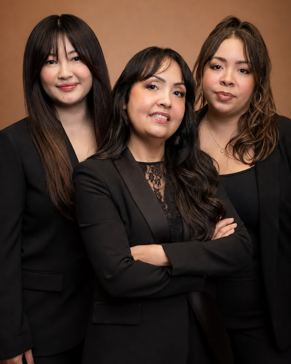 The three Christopher Anthony Salon stylists posed together in a warm editorial studio portrait