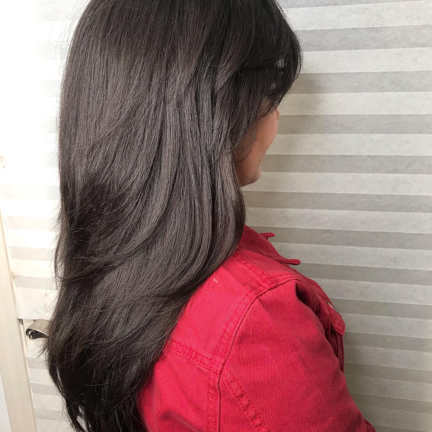 Long glossy brunette layers with a smooth finish