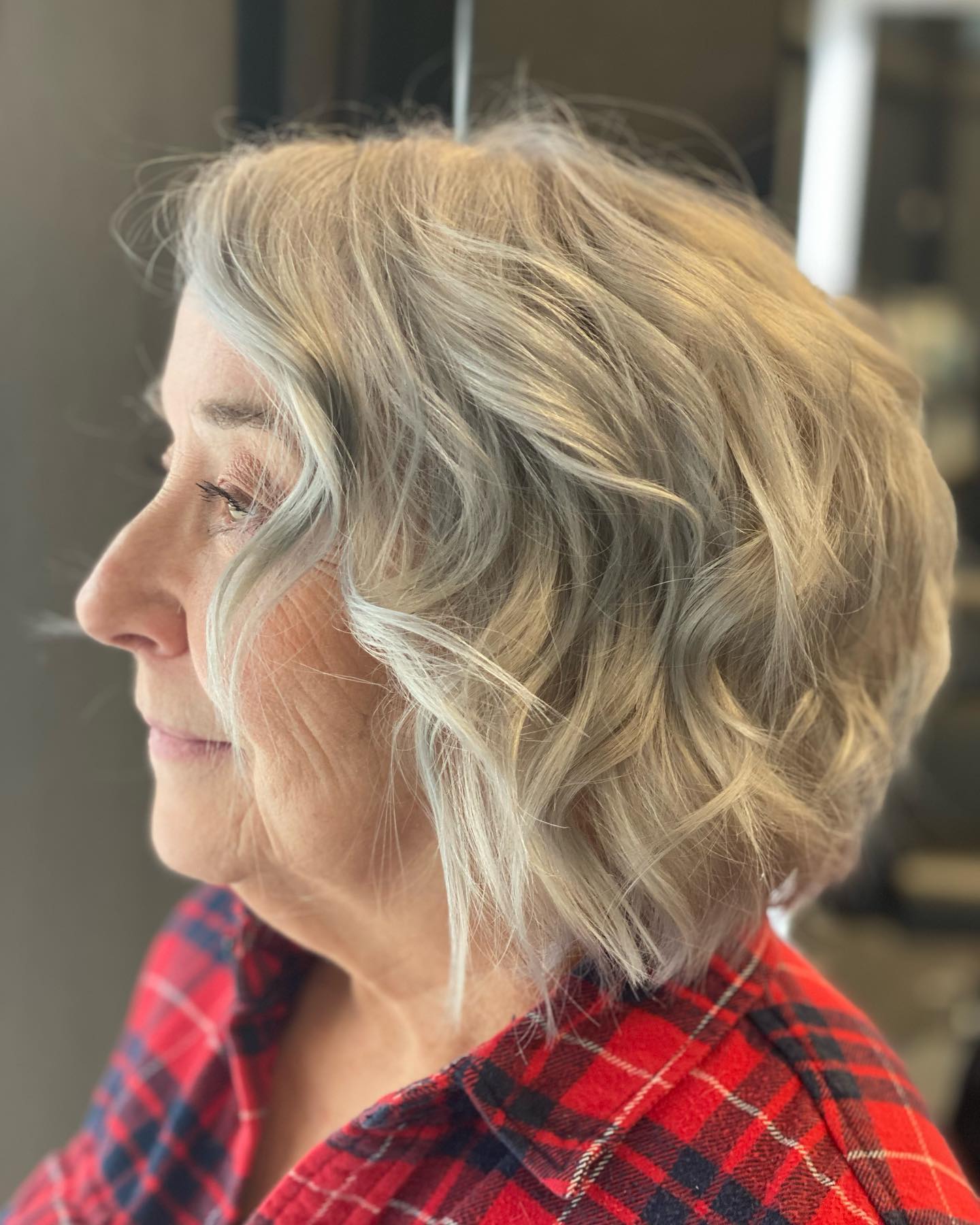Short blonde bob styled in soft waves