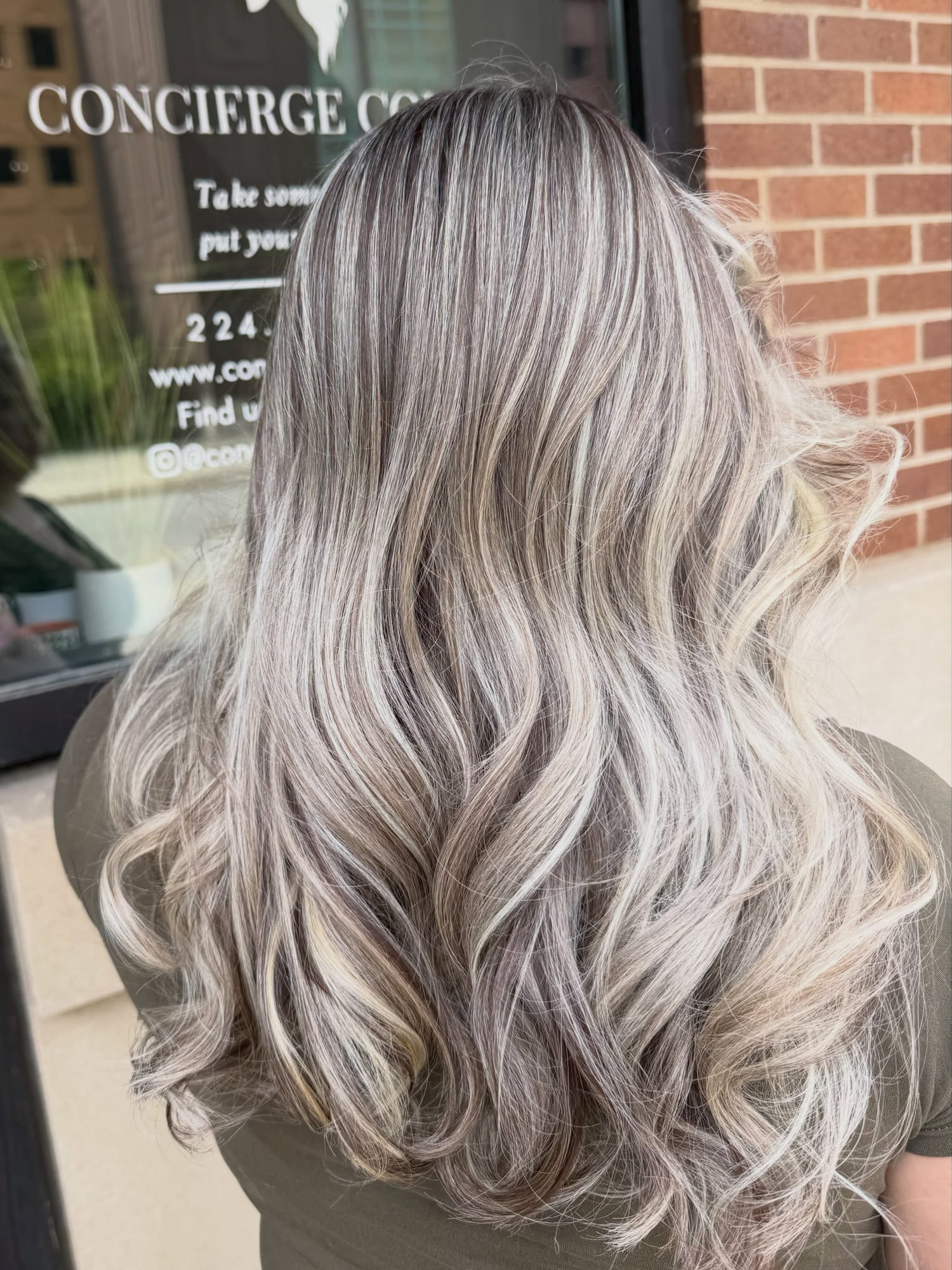 Silver ash-blonde highlights styled in soft curls